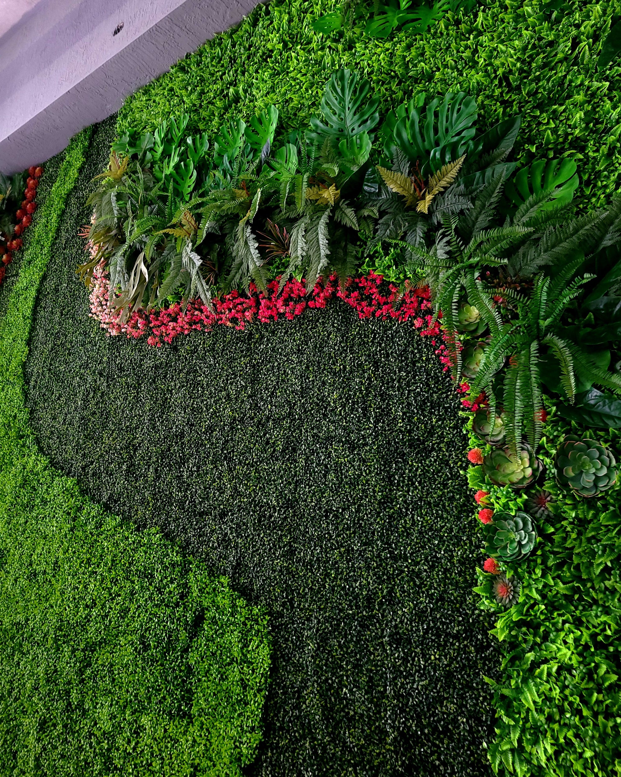 Artificial green wall with red accents