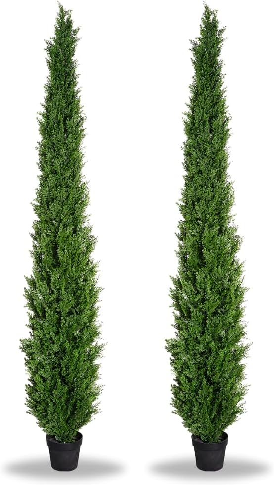 Two tall artificial trees in pots on a white background