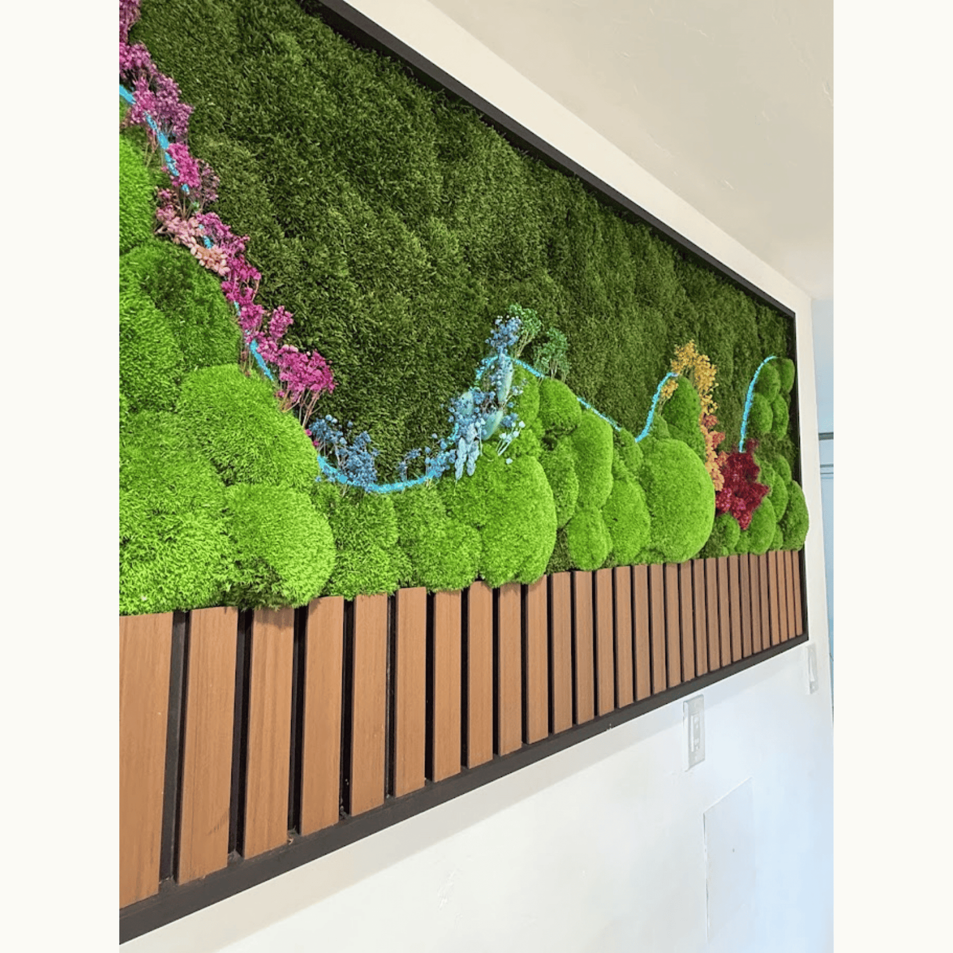 angled view of preserved moss wall art showing LED light line and colorful dried botanicals